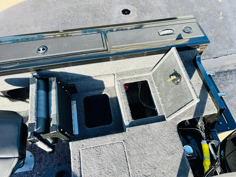 Slide: The Image of 2025 Tracker Targa V-18 Combo boat interior with storage compartments and seating. - 47