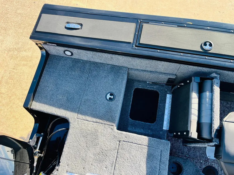 Slide: The Image of 2025 Tracker Targa V-18 Combo boat interior with storage compartments and seating. - 49
