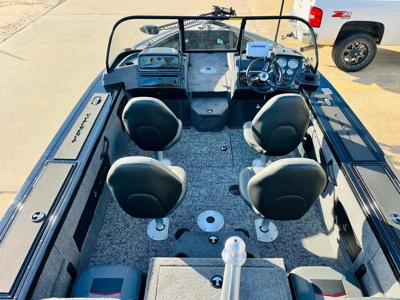 Slide: The Image of 2025 Tracker Targa V-18 Combo boat interior with four seats and dashboard. - 9