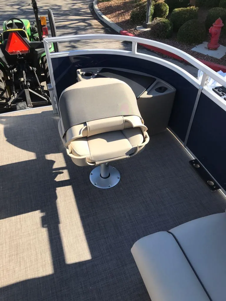 Slide: The Image of 2025 Sun Tracker Fishin' Barge 22 DLX interior with seating and railing. - 10