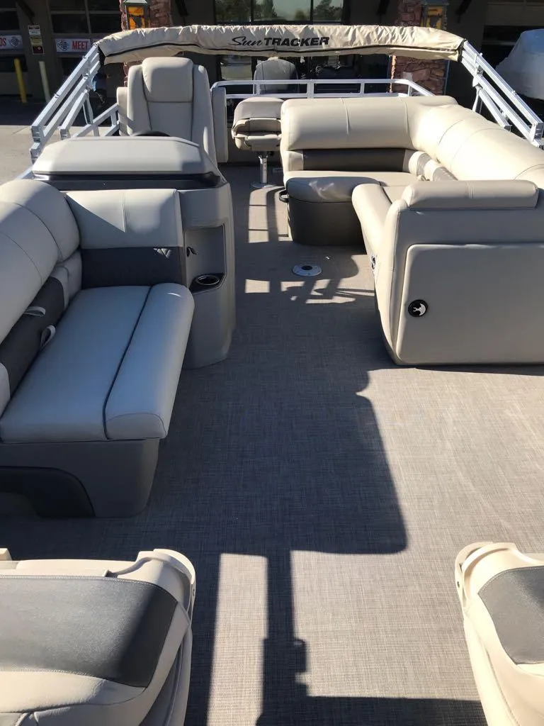 Slide: The Image of 2025 Sun Tracker Fishin' Barge 22 DLX interior with spacious seating and modern design. - 5