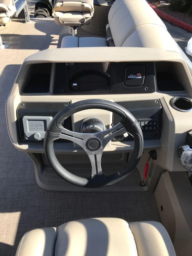 Slide: The Image of 2025 Sun Tracker Fishin' Barge 22 DLX steering console with modern controls and comfortable seating. - 6