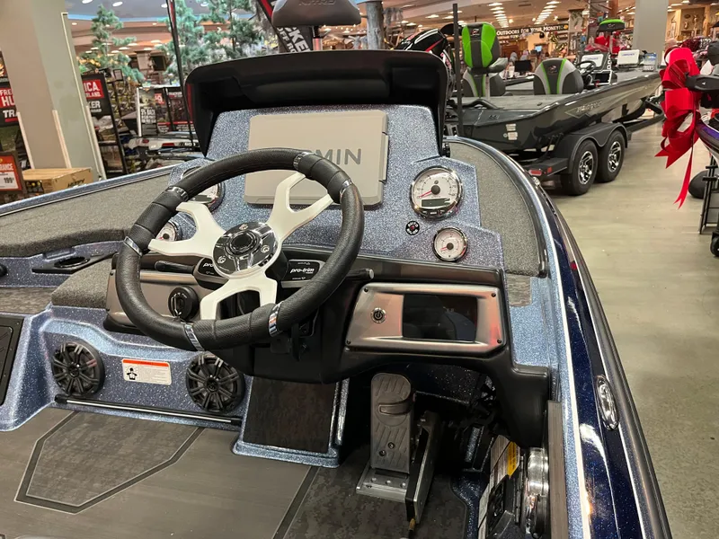 Slide: The Image of 2025 Nitro Z20 XL Pro boat dashboard with steering wheel and gauges in showroom. - 4