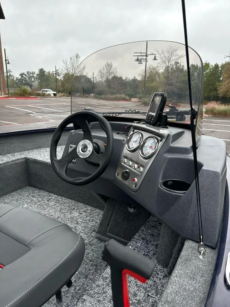 Slide: The Image of 2025 Tracker Pro Guide V-16 SC boat interior with steering wheel and dashboard controls. - 7