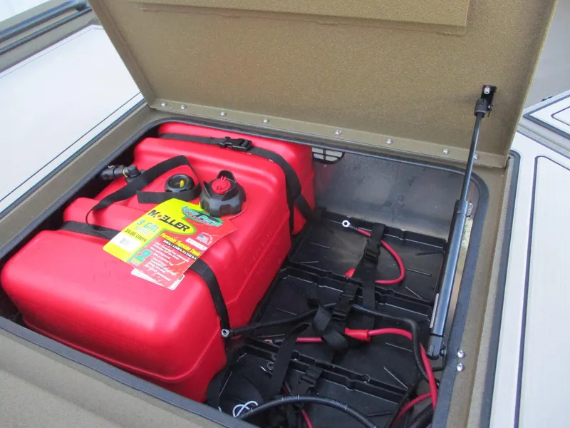 Slide: The Image of Avid 16 Commander 2025 boat storage compartment with red fuel tank and wiring. - 6