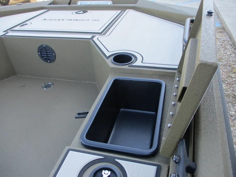 Slide: The Image of 2025 Avid 16 Commander boat interior with storage compartment and cup holder. - 7