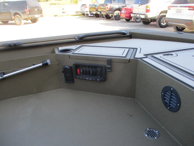 Slide: The Image of 2025 Avid 16 Commander boat interior with control panel and storage compartments. - 8