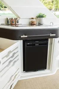 Slide: The Image of 2025 Sea Ray SLX 310 Outboard interior with kitchenette and mini fridge. - 13