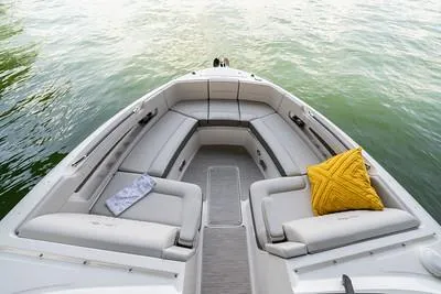 Slide: The Image of 2025 Sea Ray SLX 310 Outboard boat interior with plush seating and decorative pillows. - 14