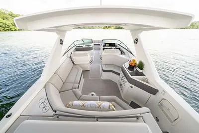 Slide: The Image of 2025 Sea Ray SLX 310 Outboard luxury boat interior with spacious seating and modern amenities. - 3