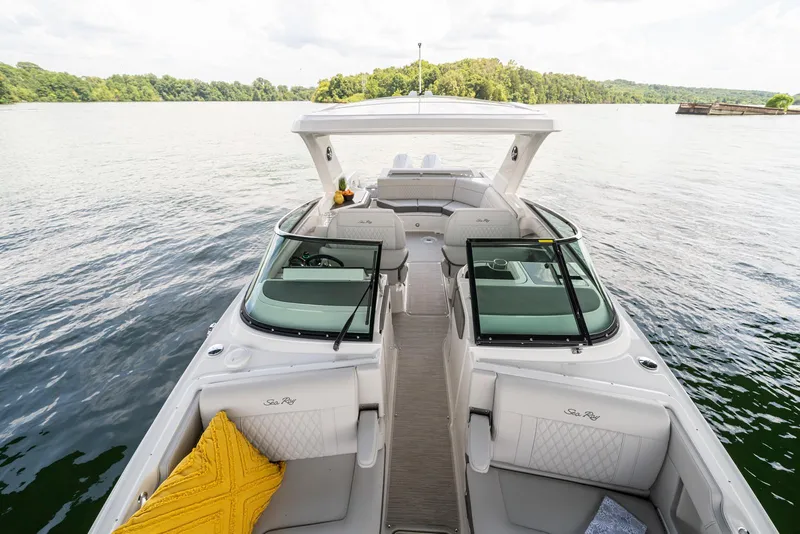 Slide: The Image of 2025 Sea Ray SLX 310 Outboard on serene lake, showcasing luxurious seating and sleek design. - 5