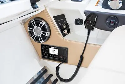 Slide: The Image of 2025 Sea Ray SLX 310 Outboard dashboard with speaker and communication equipment. - 8