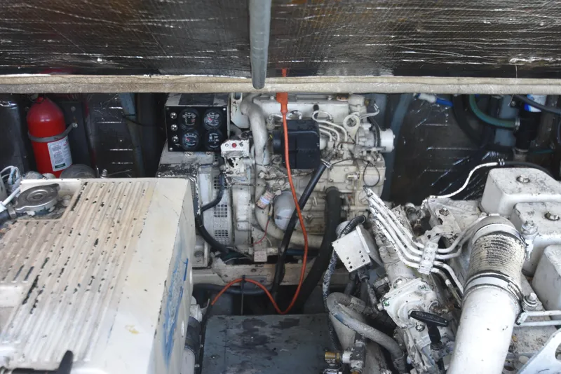 Slide: The Image of Engine compartment of a 1999 Carolina Classic 28 Express boat, featuring mechanical components. - 10