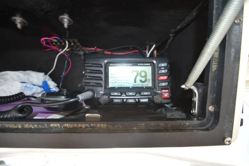 Slide: The Image of Marine radio equipment inside a 1999 Carolina Classic 28 Express boat. - 14