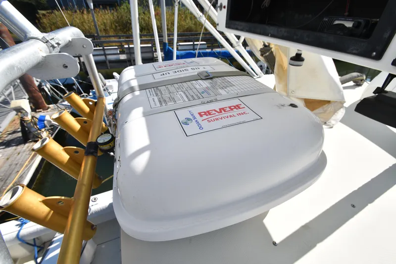 Slide: The Image of Life raft on 1999 Carolina Classic 28 Express boat deck, featuring Revere Survival Inc. label. - 15