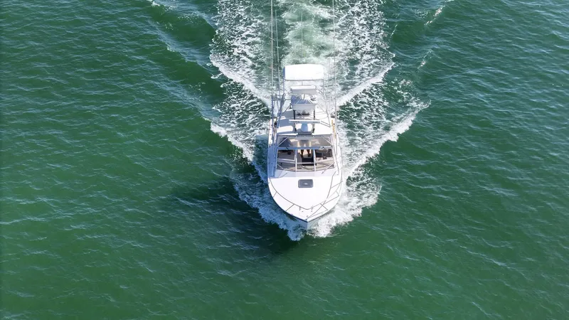 Slide: The Image of Aerial view of 1999 Carolina Classic 28 Express boat cruising on open water. - 2