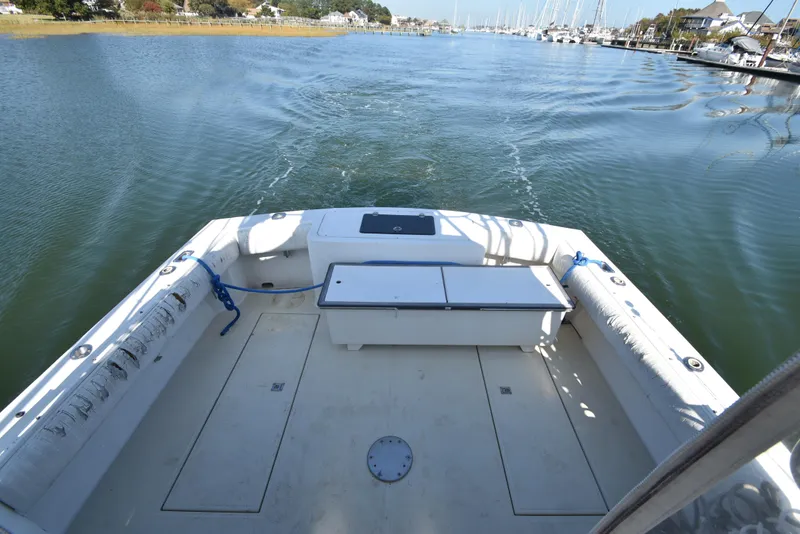 Slide: The Image of 1999 Carolina Classic 28 Express boat on calm water, view from the deck. - 5