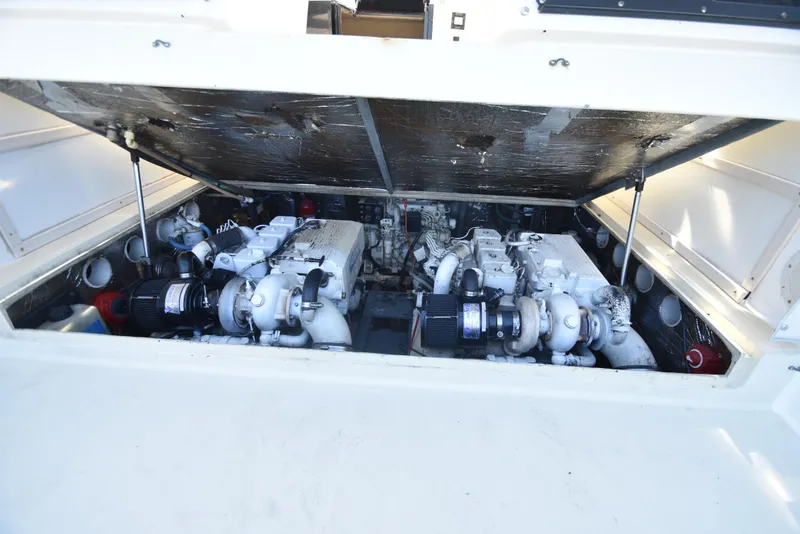 Slide: The Image of Engine compartment of a 1999 Carolina Classic 28 Express boat, showcasing dual engines. - 7