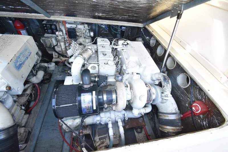 Slide: The Image of Engine compartment of a 1999 Carolina Classic 28 Express boat, showcasing mechanical components. - 8