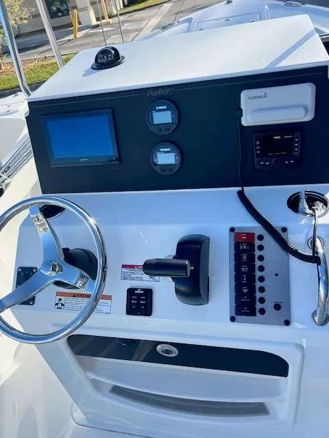 Slide: The Image of 2025 Parker 21 SE CC boat dashboard with steering wheel and control panel. - 10