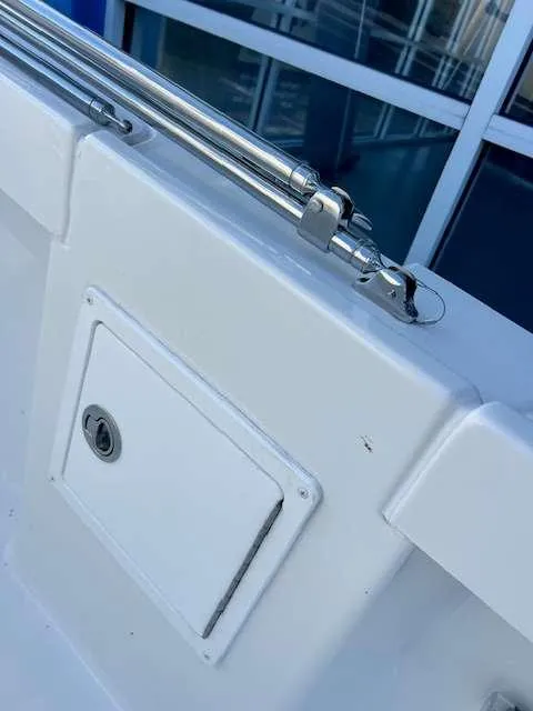 Slide: The Image of Parker 21 SE CC 2025 boat detail with stainless steel fittings and storage compartment. - 11
