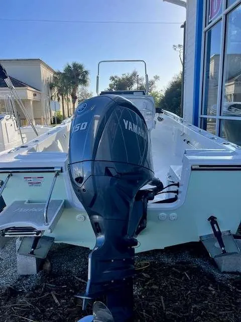 Slide: The Image of 2025 Parker 21 SE CC boat with Yamaha 150 engine, docked outdoors. - 3