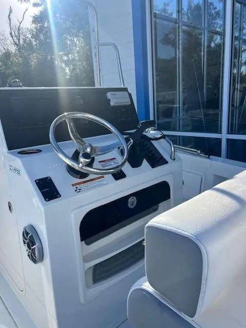 Slide: The Image of 2025 Parker 21 SE CC boat helm with steering wheel and controls. - 6