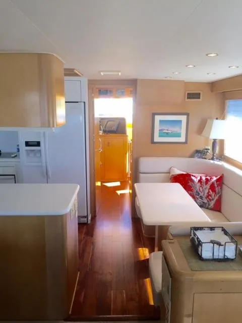 Slide: The Image of Interior of 1998 Hatteras 74 Sport Deck yacht with modern kitchen and dining area. - 4