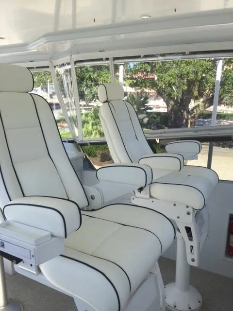 Slide: The Image of Luxurious white captain chairs on 1998 Hatteras 74 Sport Deck yacht. - 14