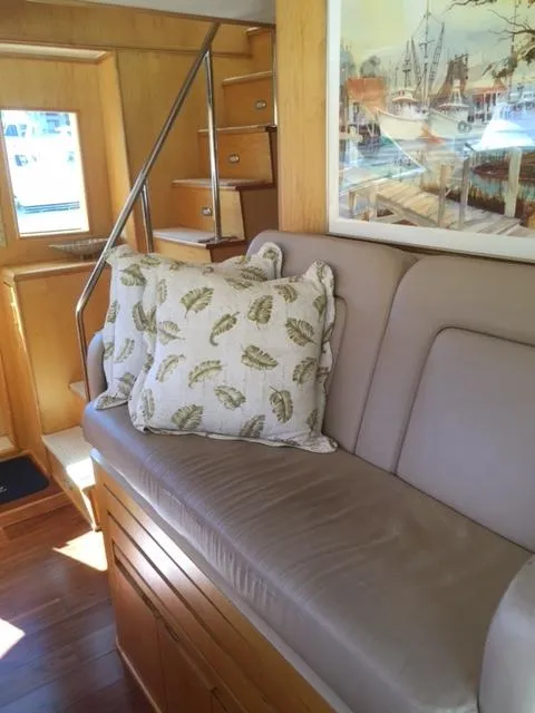 Slide: The Image of Interior of 1998 Hatteras 74 Sport Deck yacht with beige sofa and decorative pillows. - 16