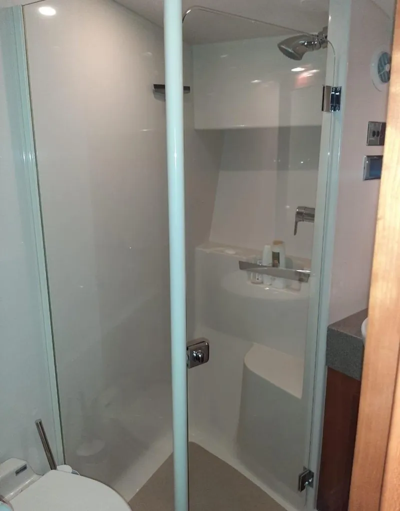 Slide: The Image of Bathroom in 2009 Riviera 47 Enclosed Flybridge Series II yacht, featuring modern shower design. - 16
