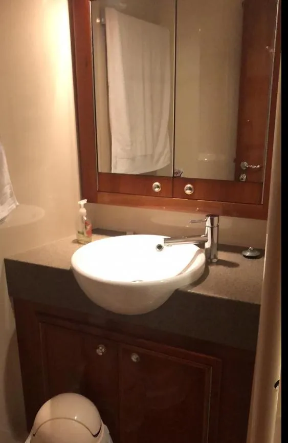 Slide: The Image of 2009 Riviera 47 Enclosed Flybridge Series II bathroom with sink and mirror. - 21