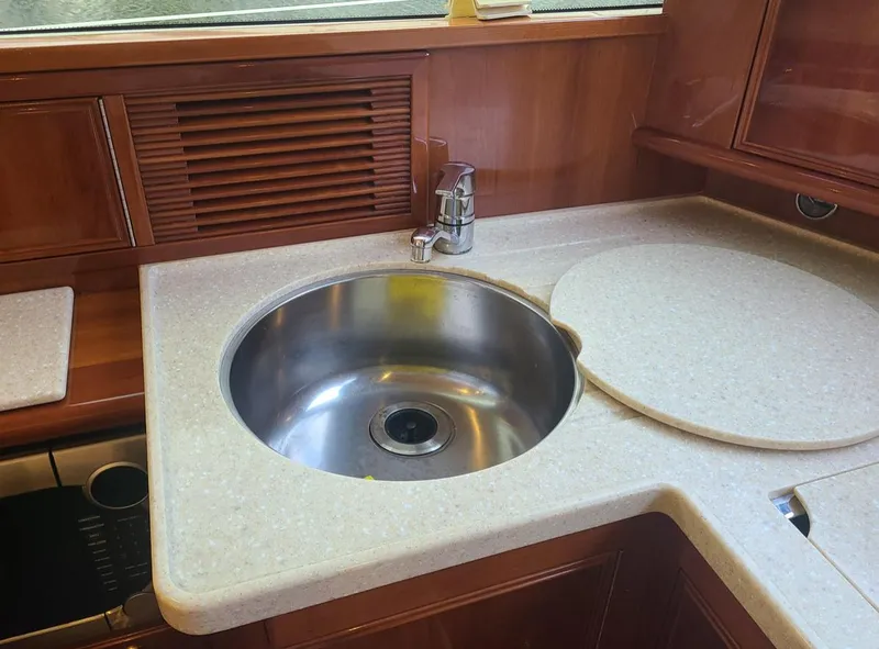 Slide: The Image of 2009 Riviera 47 Enclosed Flybridge Series II yacht kitchen sink and countertop. - 30
