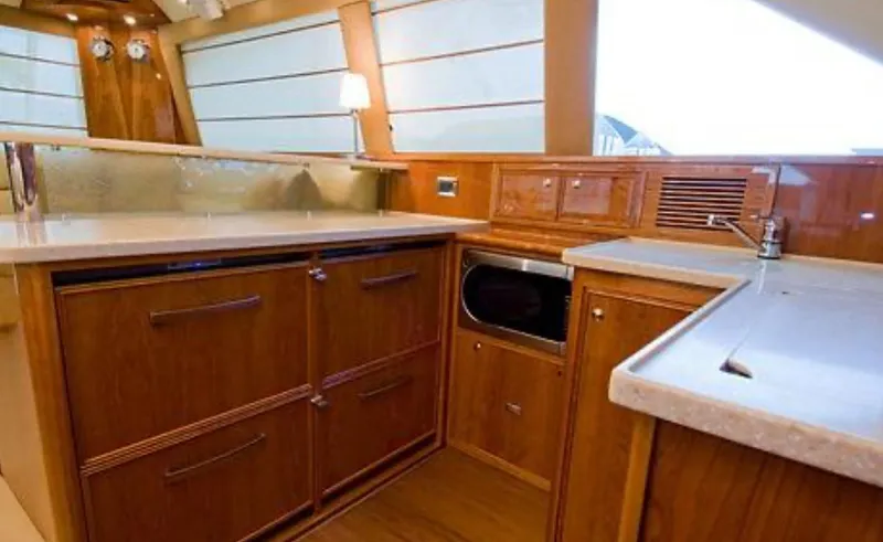 Slide: The Image of Luxurious kitchen interior of 2009 Riviera 47 Enclosed Flybridge Series II yacht. - 33