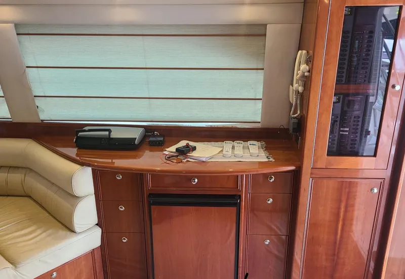 Slide: The Image of Interior of 2009 Riviera 47 Enclosed Flybridge Series II with wooden cabinetry and seating. - 36