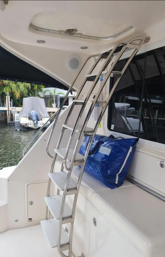 Slide: The Image of Stainless steel ladder on 2009 Riviera 47 Enclosed Flybridge Series II yacht deck. - 46