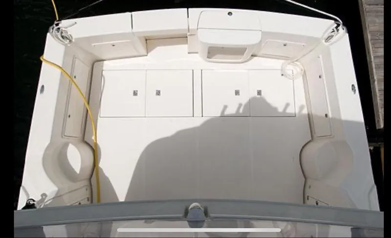 Slide: The Image of 2009 Riviera 47 Enclosed Flybridge Series II boat deck, featuring spacious seating and storage. - 47