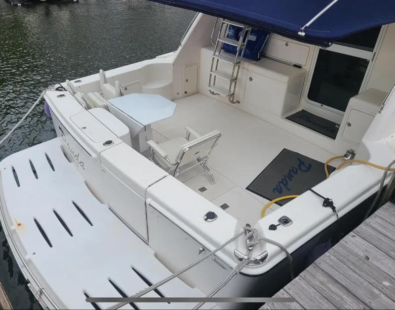 Slide: The Image of 2009 Riviera 47 Enclosed Flybridge Series II yacht with spacious deck and seating area. - 48