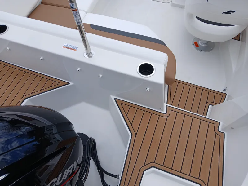 Slide: The Image of 2025 Starcraft SVX 171 OB boat interior with wood finish and Mercury engine. - 4