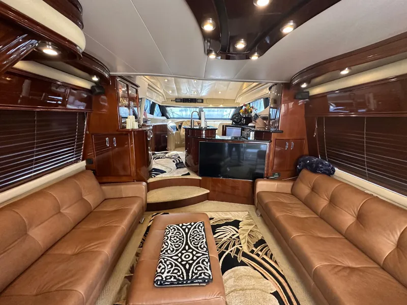 Slide: The Image of Luxurious interior of a 2004 Marquis 59 yacht with leather seating and elegant wood finishes. - 12