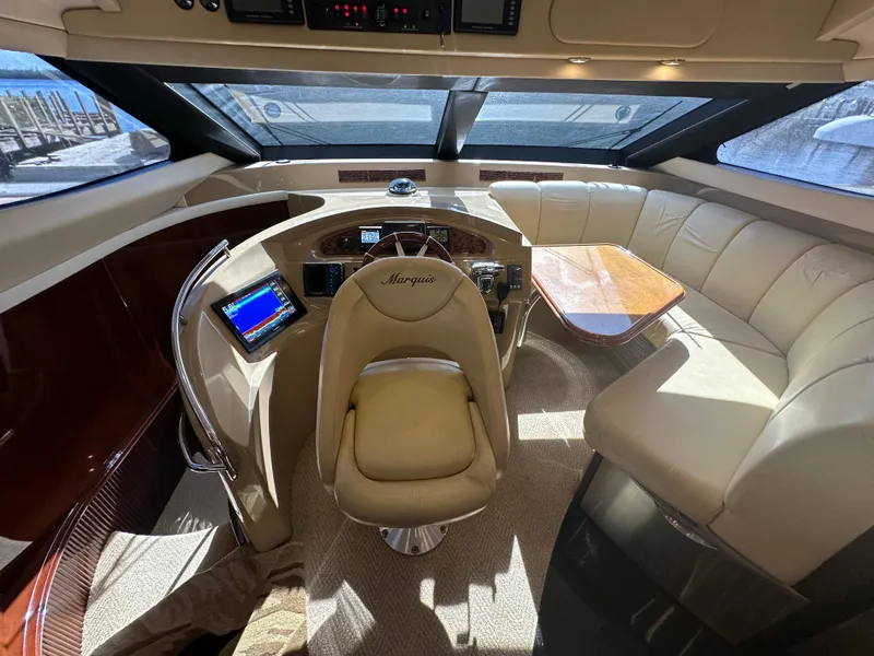 Slide: The Image of Luxurious 2004 Marquis 59 yacht interior with leather seating and modern helm. - 15