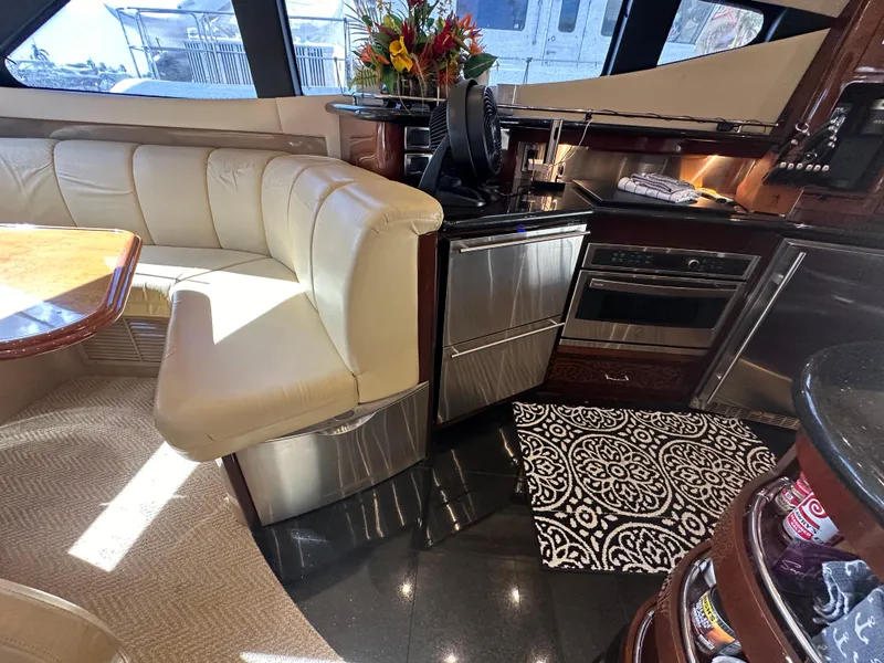 Slide: The Image of Luxurious interior of a 2004 Marquis 59 yacht with modern kitchen and seating area. - 16