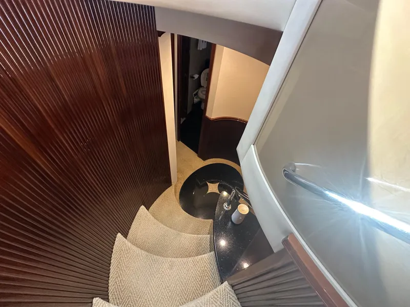 Slide: The Image of Interior staircase of 2004 Marquis 59 yacht with elegant wood paneling. - 17