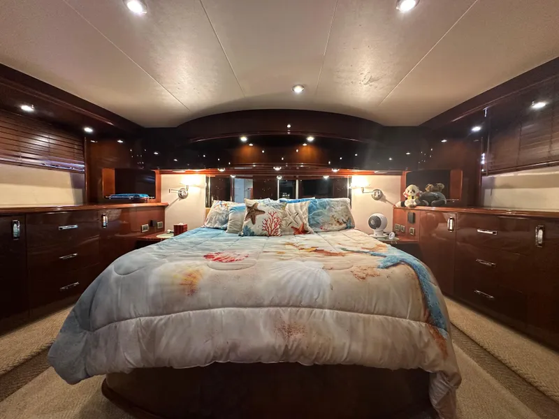 Slide: The Image of Luxurious bedroom interior of 2004 Marquis 59 yacht with elegant wood finishes. - 18
