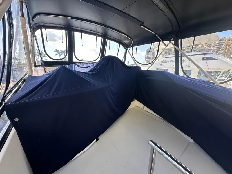 Slide: The Image of 2004 Marquis 59 yacht interior with blue covers and panoramic windows. - 25