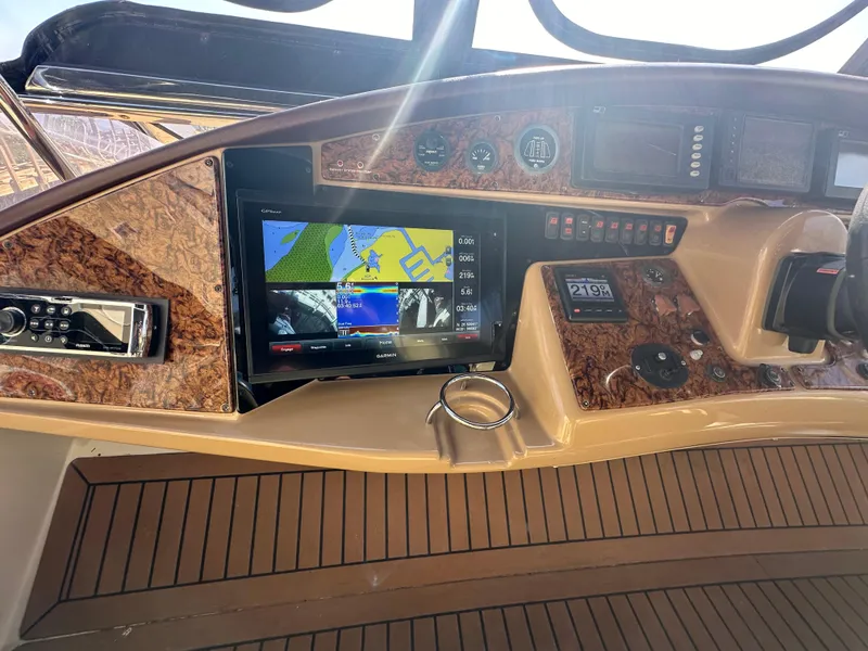 Slide: The Image of 2004 Marquis 59 yacht dashboard with navigation system and wood finish. - 33