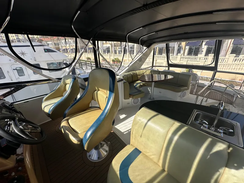 Slide: The Image of Luxurious 2004 Marquis 59 yacht interior with plush seating and helm. - 34