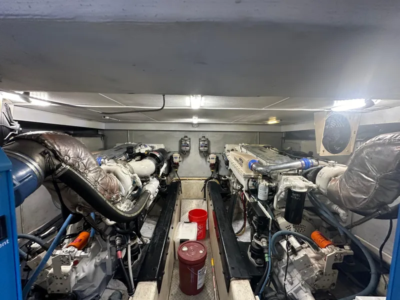 Slide: The Image of Engine room of a 2004 Marquis 59 yacht, featuring dual engines and equipment. - 35