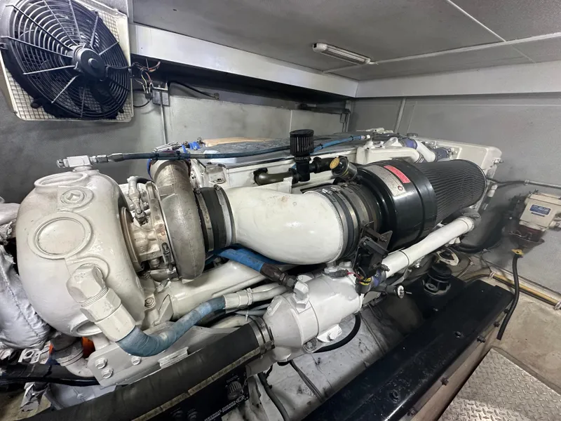 Slide: The Image of 2004 Marquis 59 engine room with a powerful marine engine and ventilation fan. - 36