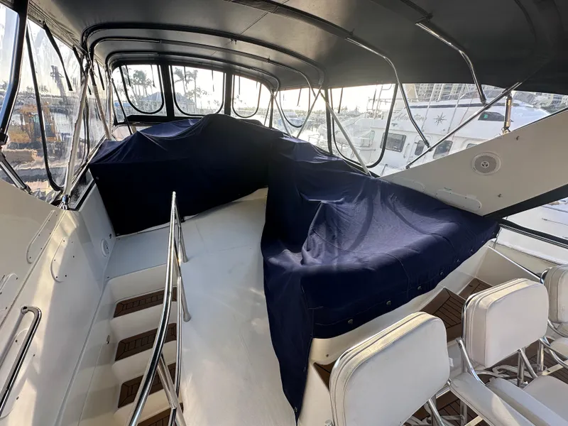 Slide: The Image of Interior view of a 2004 Marquis 59 yacht with covered seating area. - 40